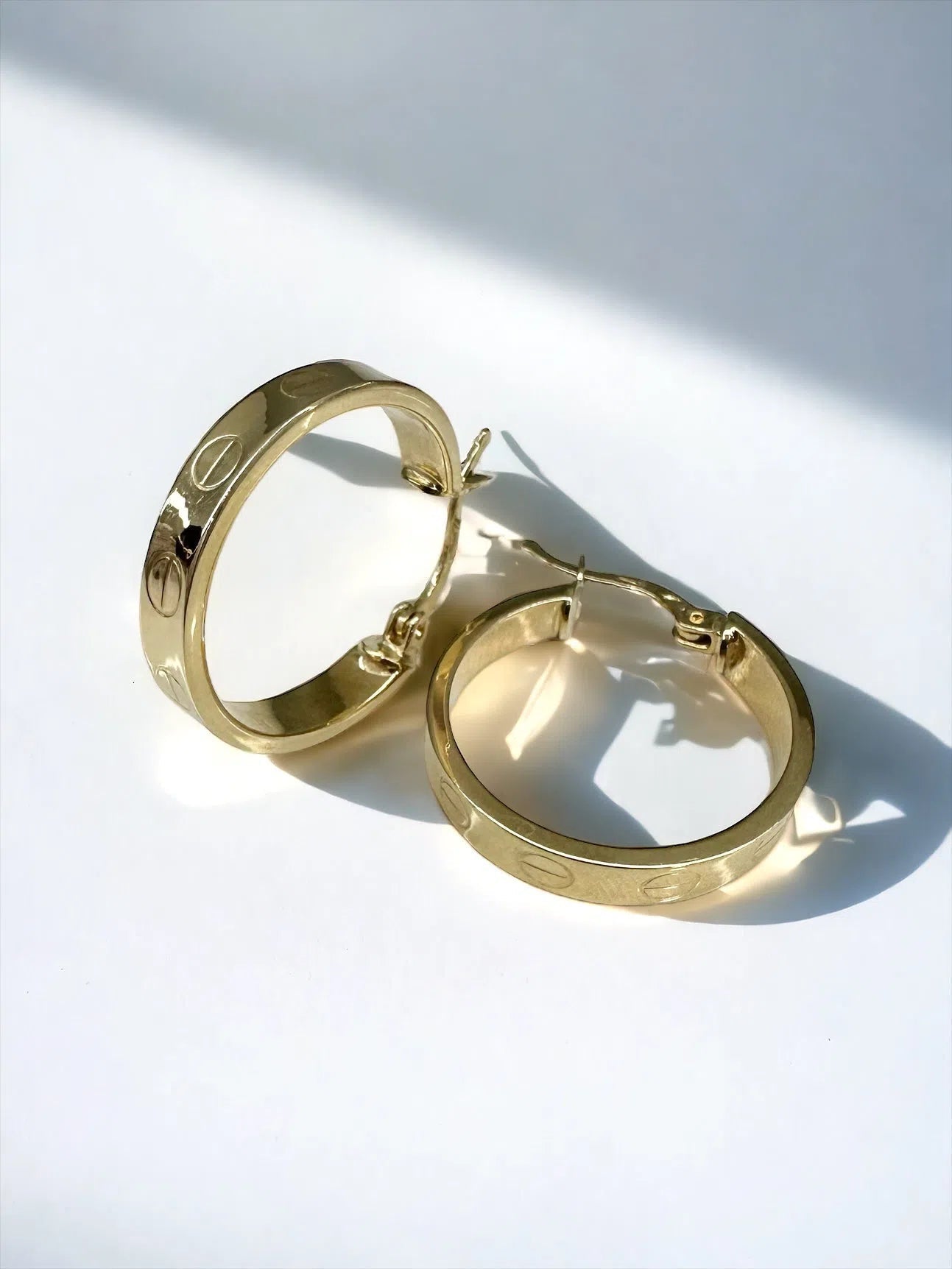 Gold hoop earrings, shiny